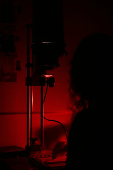 a woman sitting at a desk in a dark room