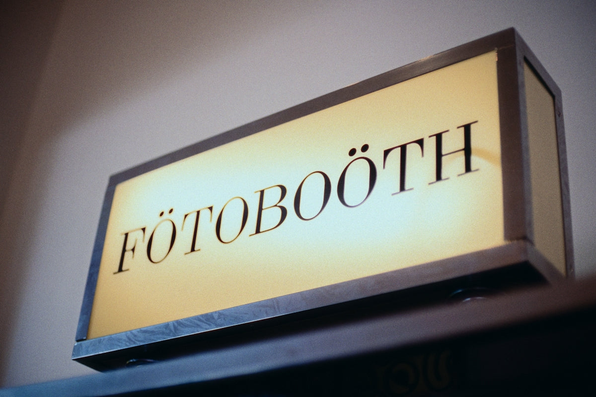 The photo booth sign is illuminated and ready.